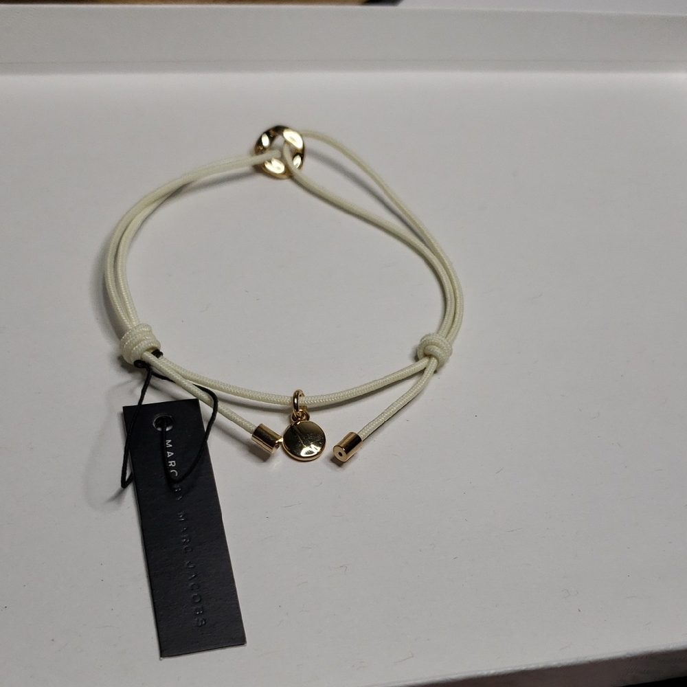 Marc by Marc Jacobs Cord Friendship Bracelet in Cream with a Gold-Tone Charm. 